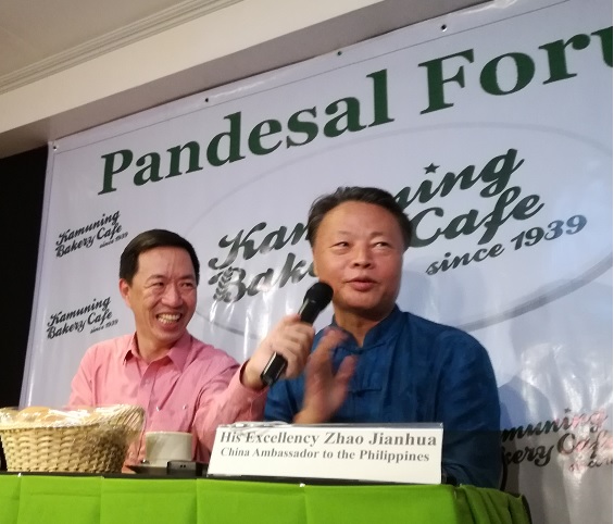 Chinese Ambassador Zhao Jianhua gives a briefing of Pres. Duterte's China visit Oct. 14. With him is Philstar columnist Wilson Flores, owner of Kamuning Bakery where presscon was held.